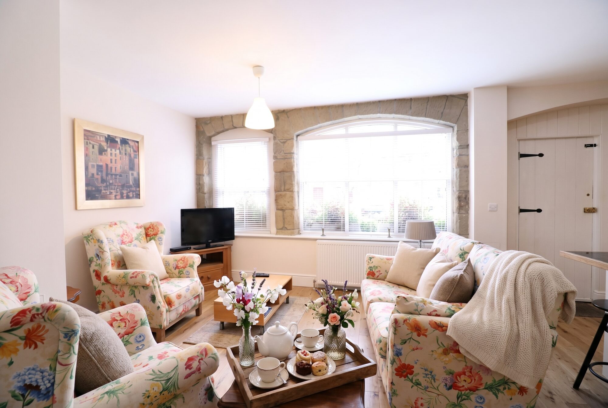 Stable Cottage sitting room with arched stone window