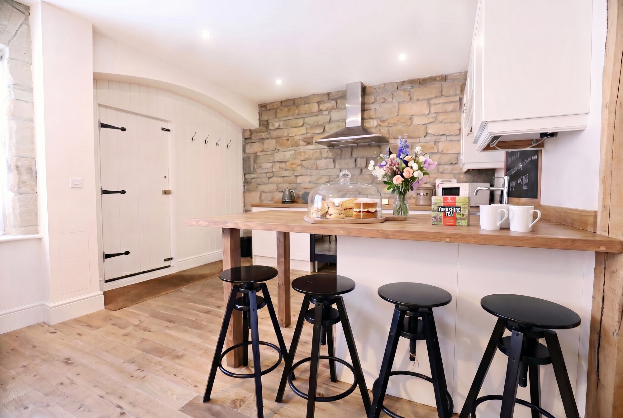 Stone-walled kitchen with breakfast bar